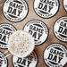 Black and white Game Day coasters arranged around a drink, showing the bold varsity-style personalized design.