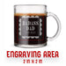 A glass mug with an engraved design on it. The mug is filled with tea, and there is text under the mug that reads "Engraving Area is 2 in x 2 in”