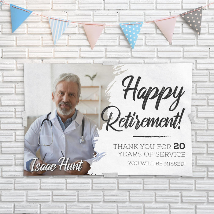 Retirement banner mounted on a white brick wall featuring a custom photo, retirement message, and service recognition. Perfect for retirement party décor and photos.