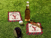 Custom square pulpboard coasters are shown sitting on a grassy, green golf course next to a bottle of beer, white golf ball, and golf club. The coasters feature design with an illustration of a golf ball on a tee, checkerboard border, and custom text.