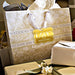 Wedding gift bags and favor boxes displayed with personalized “With Love” gold foil wedding gift tags. Styled for elegant wedding receptions, showers, and celebration tables.