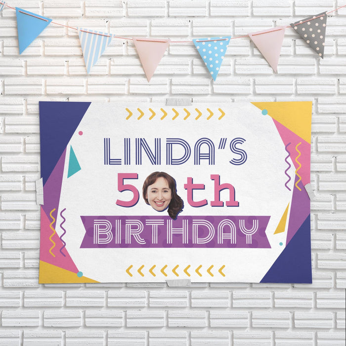 Personalized retro 80s birthday banner displayed on a white brick wall with party bunting.