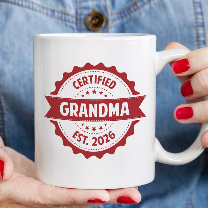 Personalized Grandma mug held in hand with custom established year badge design.