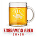 A glass mug with an engraved design on it. The mug is filled with tea, and there is text under the mug that reads "Engraving Area is 2 in x 2 in”