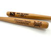 two baseball bats with custom logos and text sitting on top of a white surface 