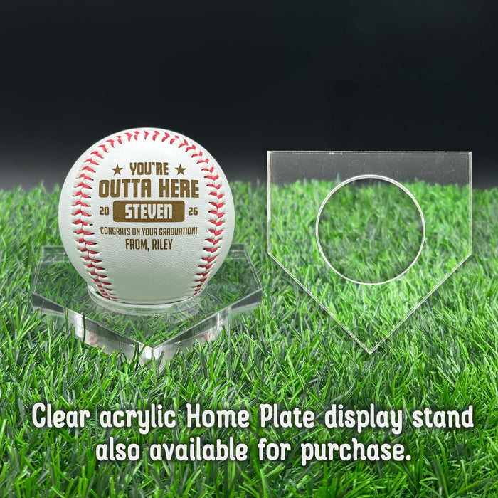 A personalized baseball with red stitching is placed on a clear acrylic stand, accompanied by a text overlay that reads Clear acrylic Home Plate display stand also available for purchase.