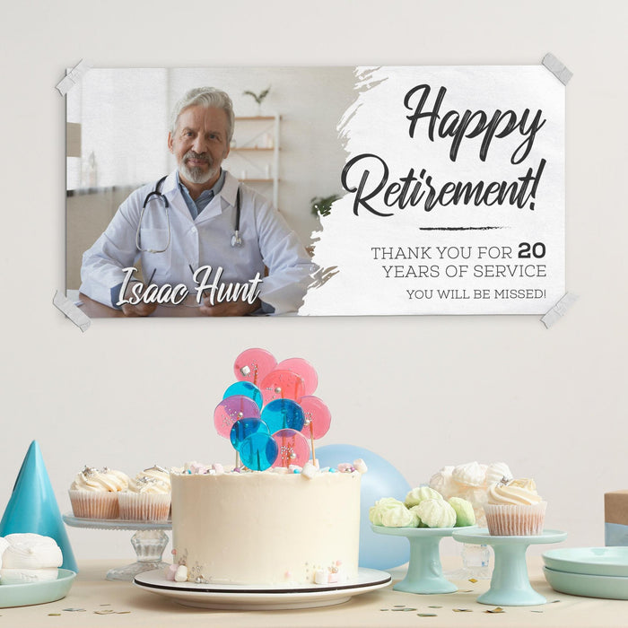 Happy Retirement banner displayed above a party table with cake and decorations. Personalized retirement backdrop designed for farewell parties and celebrations.