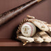A baseball bat and a baseball glove are placed on a shelf, with a baseball resting inside the glove.