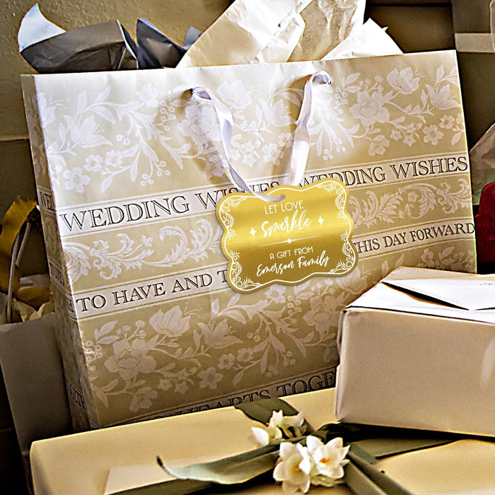 Wedding gift bags and favor boxes displayed with personalized “Let Love Sparkle” gold foil wedding gift tags. Styled for weddings, bridal showers, and elegant celebration gifting.