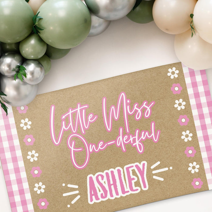 Angled view of the personalized birthday banner highlighting the pink gingham border, flower details, and custom name personalization.