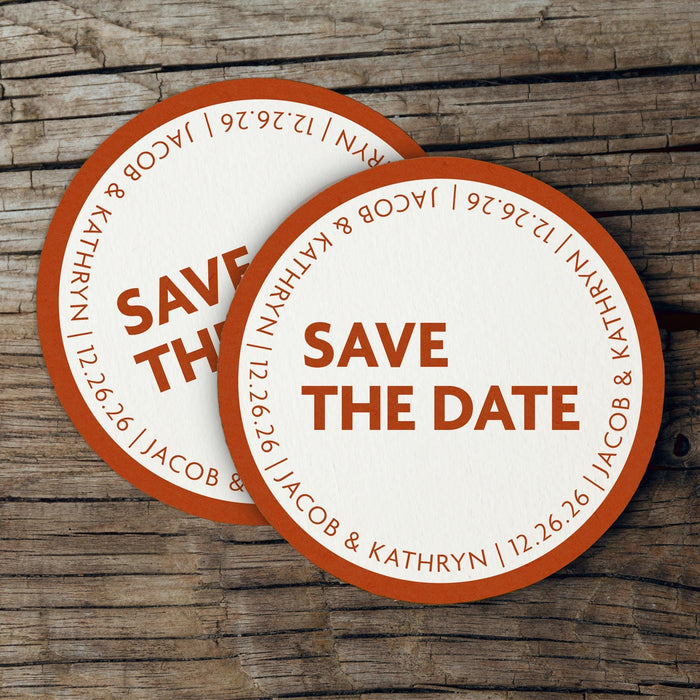 Stack of personalized Save the Date coasters displayed on a rustic wood background. Modern wedding favors customized with names and date.