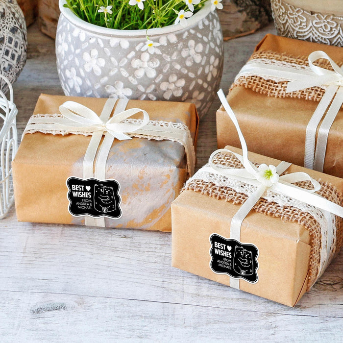 Multiple wrapped wedding gifts displayed with personalized foil wedding gift tags attached to the ribbon. The tags create a stylish and coordinated presentation for special occasions.
