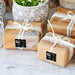 Multiple wrapped wedding gifts displayed with personalized foil wedding gift tags attached to the ribbon. The tags create a stylish and coordinated presentation for special occasions.