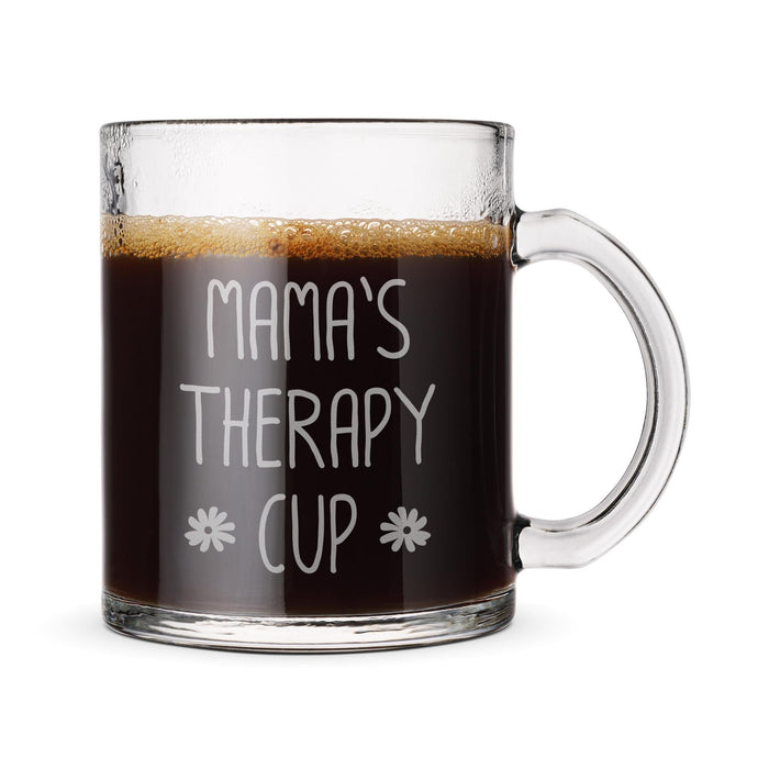 A glass mug filled with a dark liquid, likely coffee, with the text "Mama's Therapy Cup" engraved on it.