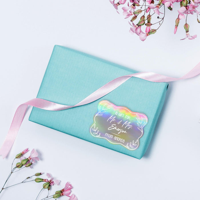 Pastel blue box with ribbon accented by a holographic rainbow “Mr. & Mrs.” personalized wedding gift tag. A modern wedding stationery and gift packaging display.
