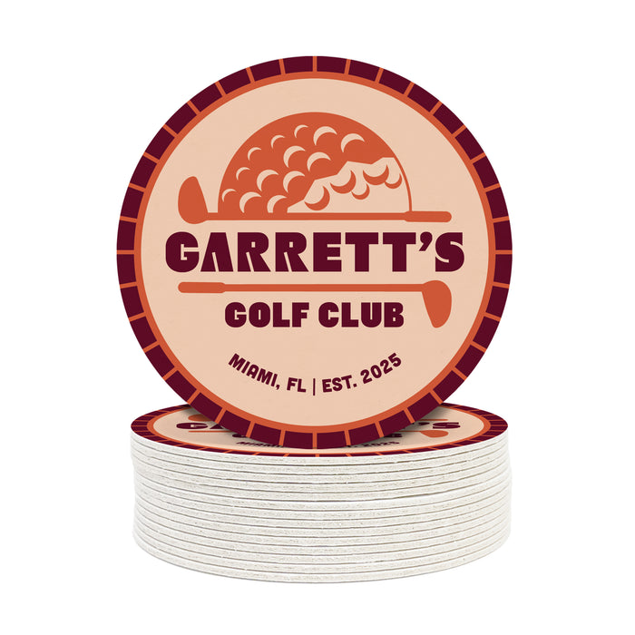 A circular coaster with the text "GARRETT'S GOLF CLUB" and "MIDI, FL | EST. 2025" printed on it.