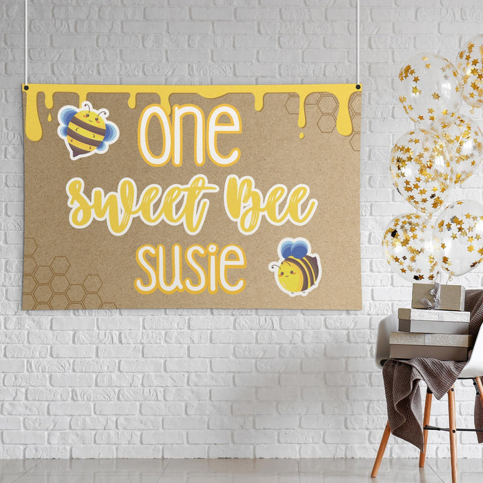 Styled display of the One Sweet Bee banner showing the butcher paper texture, bee graphics, and yellow first birthday theme.