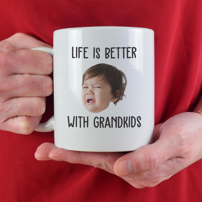 Personalized grandkids mug held against a red shirt with custom child photo.