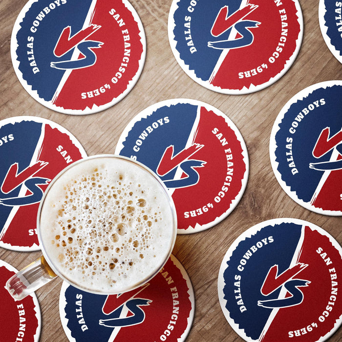 Red and blue rivalry coasters arranged around a drink, showing the bold VS design and opposing team names.