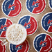 Red and blue rivalry coasters arranged around a drink, showing the bold VS design and opposing team names.