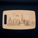 Full view of the Paris skyline cutting board on a dark background with the laser engraved city design clearly visible.