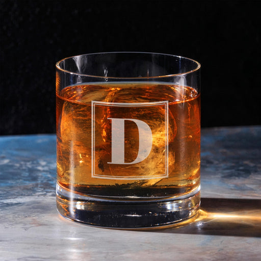 Clean hero-style image of the personalized whiskey glass on a marble surface, featuring the framed “D” initial. The engraving appears crisp and professionally finished.