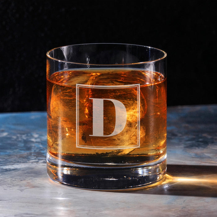 Clean hero-style image of the personalized whiskey glass on a marble surface, featuring the framed “D” initial. The engraving appears crisp and professionally finished.