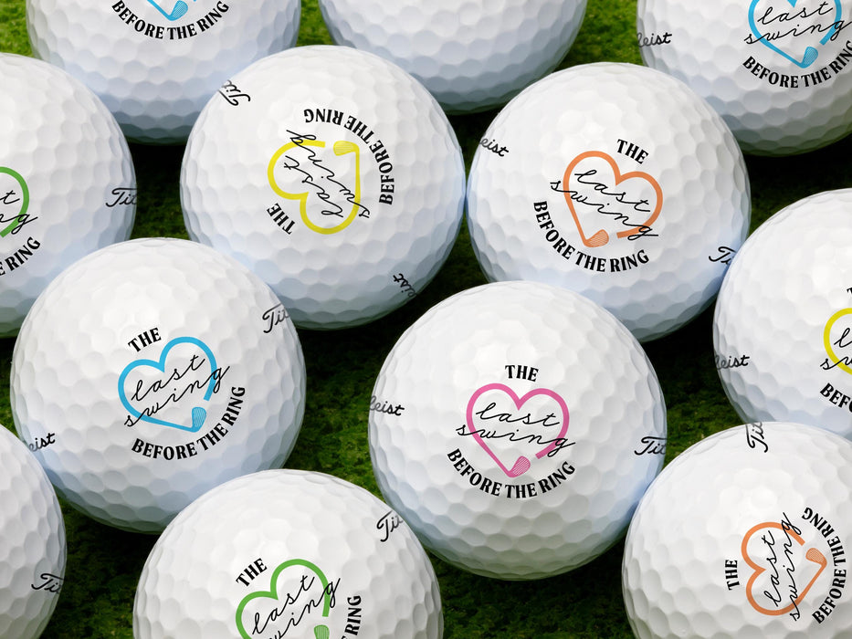 Multiple Titleist golf balls shown with different colors on each ball. Golf balls sit on a grassy surface.