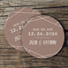 Custom Save the Date coaster displayed on a rustic wood background. Features a clean geometric border design with personalized details.