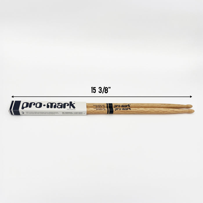 A packaged set of drumsticks sit on a white surface. The drumsticks are 15 3/8 inches in length.
