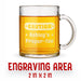 A glass mug with an engraved design on it. The mug is filled with tea, and there is text under the mug that reads "Engraving Area is 2 in x 2 in”