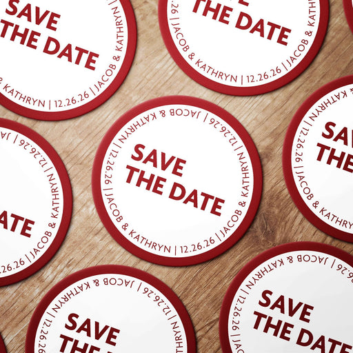 Personalized Save the Date coasters shown in a wedding favor arrangement. Modern wedding design customized with names and date.