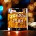 Elegant product photo of the engraved whiskey glass filled with whiskey and ice against a soft bokeh background. The custom “Crafted For John” design is centered and clearly visible, perfect for showcasing the finished personalized gift.