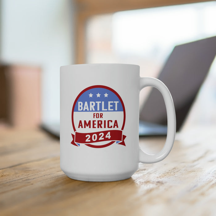 White mug ontop of wooden desk in front of laptop that has red white and blue American flag design with typography that says Bartlet for America 2024