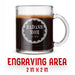 A glass mug with an engraved design on it. The mug is filled with tea, and there is text under the mug that reads "Engraving Area is 2 in x 2 in”