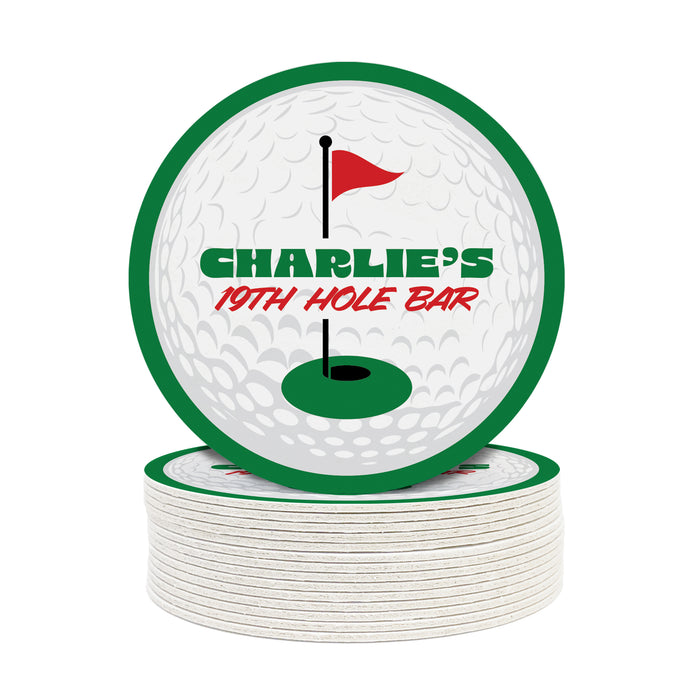 A stack of white coasters with a golf ball design and a red flag on top, along with the text "CHARLIE'S 19TH HOLE BAR".
