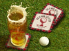 Custom square pulpboard coasters are shown sitting on a grassy, green golf course next to a pint of beer and a white golf ball. The pint of beer has a golf ball splashing into it and has a coaster underneath it. The coasters feature design with an illustration of a golf ball on a tee, checkerboard border, and custom text.