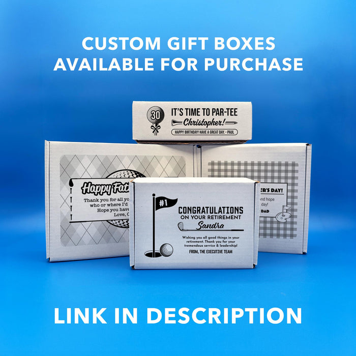 A collection of gift boxes with various designs and text, including a "Happy Father's Day" box, a "Happy 1st Father's Day" box, and a Retirement box, and a golf-themed Birthday box. The text on the photo says, "Custom Gift Boxes Available for Purchase. Link in Description."