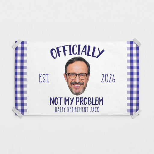 Personalized Officially Not My Problem retirement banner featuring a custom photo, retirement year, and retiree name. Fun retirement party decoration printed on white paper with a blue gingham border.