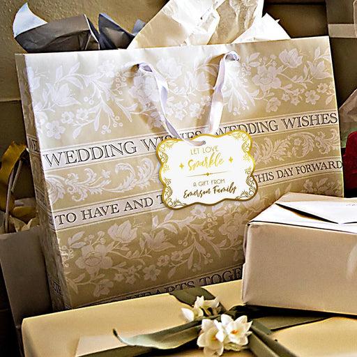 Wedding gift bags and favor boxes decorated with personalized “Let Love Sparkle” foil wedding gift tags. Styled for elegant weddings, bridal showers, and engagement celebrations.