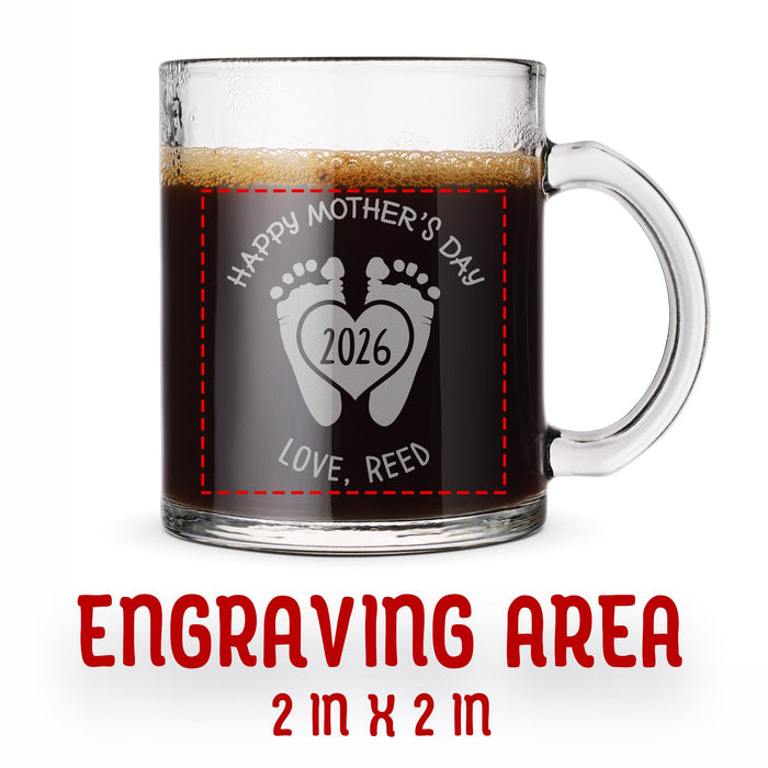 A glass mug with an engraved design on it. The mug is filled with tea, and there is text under the mug that reads "Engraving Area is 2 in x 2 in”