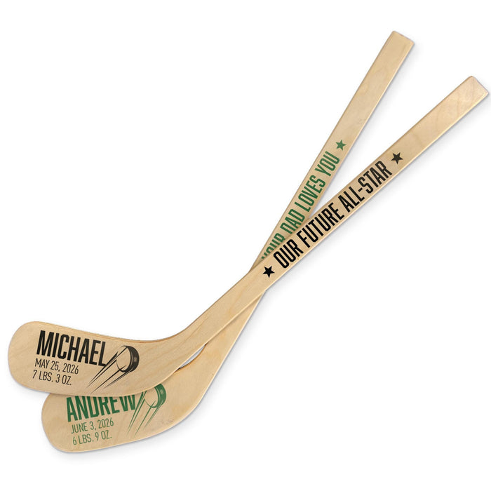 Set of personalized hockey sticks showing different color variations of the baby name and birth info design, each with bold name text and small graphic accents.