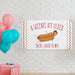Birthday banner displayed on a white brick wall with colorful balloons and party decorations.
