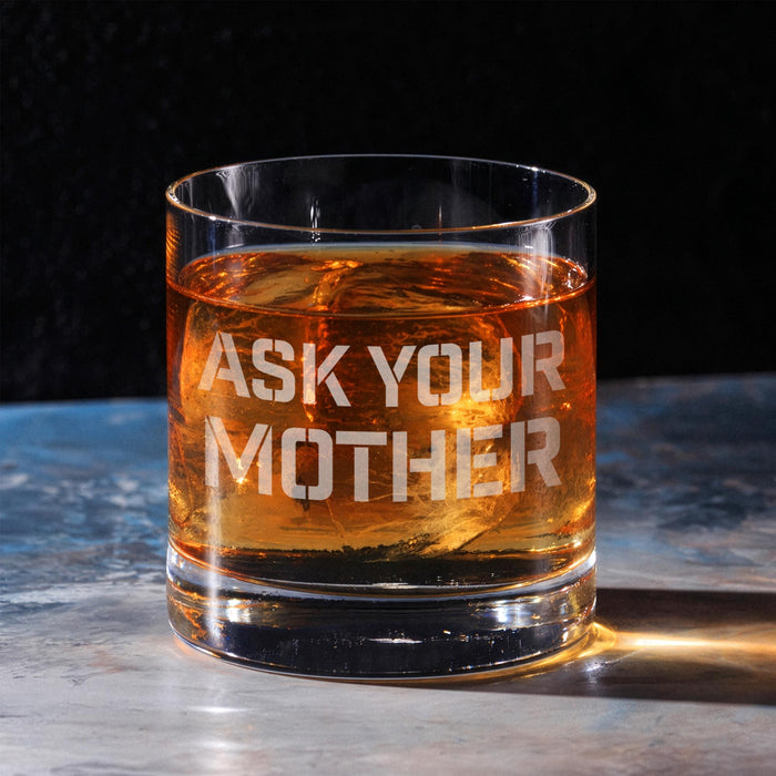 Clean hero-style image of a whiskey glass on a marble surface featuring the bold “Ask Your Mother” engraved design. The rich whiskey color highlights the crisp and humorous engraving.