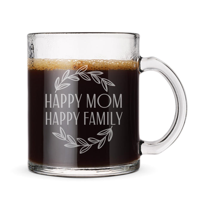 A glass mug filled with a dark liquid, likely coffee, with the text "HAPPY MOM HAPPY FAMILY" engraved on it.