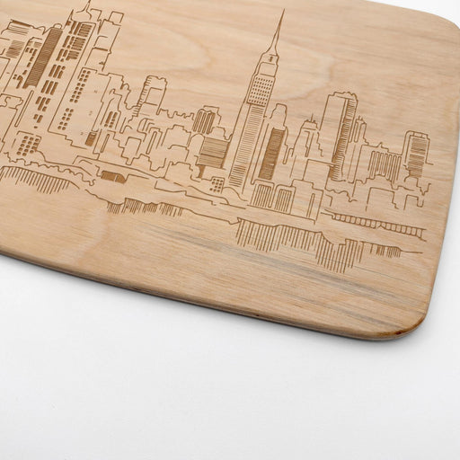 Close-up of the laser engraved New York City skyline with New York lettering on the maple cutting board.