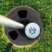 Top view of a personalized retirement golf ball resting in a golf cup. Features the Retired Monogram design with custom initials and retirement year.