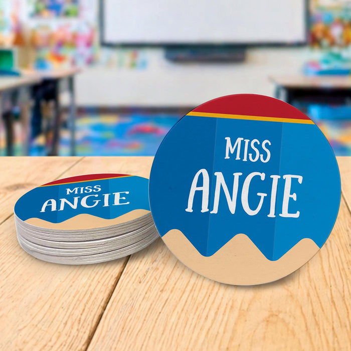 Personalized teacher coasters displayed in a classroom setting. Demonstrates real-life teacher desk use.