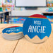 Personalized teacher coasters displayed in a classroom setting. Demonstrates real-life teacher desk use.