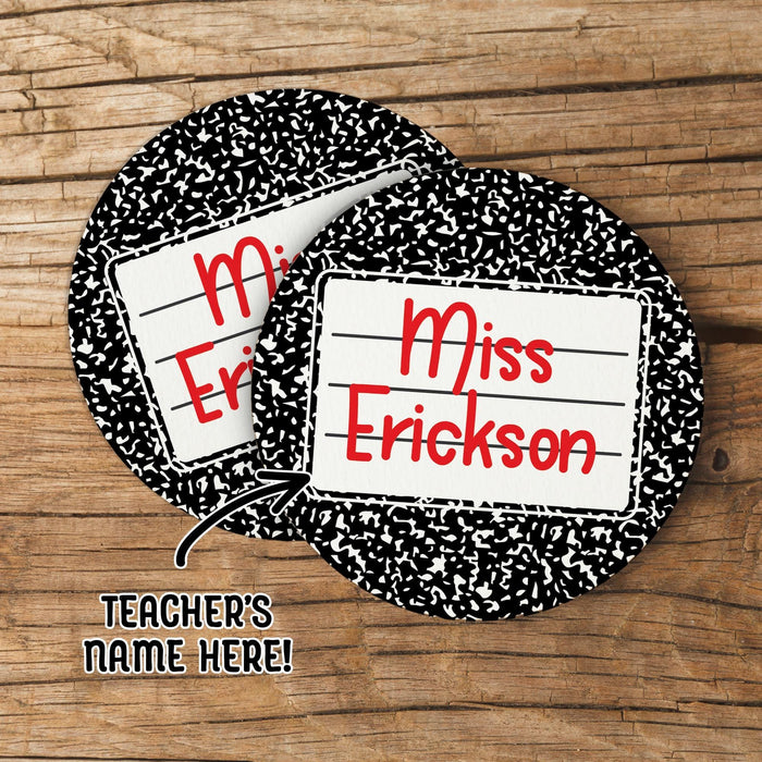 Personalized teacher coasters featuring composition notebook design with custom teacher name. Shown on a wood background as a gift preview.